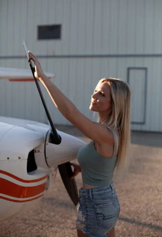 Kristy adjusting the propeller of a small plane