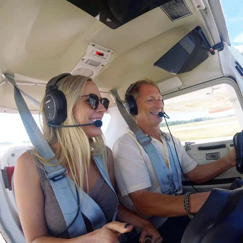 Kristy inside a plane with a headset on