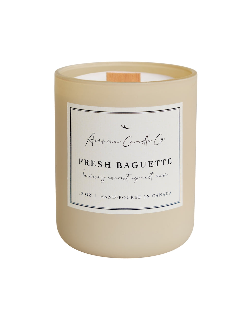 "Fresh Baguette" candle in a cream coloured jar. There is a white square label on the candle stating the name of the business, scent, "luxury coconut apricot wax", size, and "hand-poured in Canada".