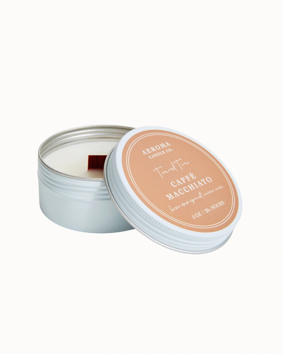 Candle in a tin with a light orange lid on a white background