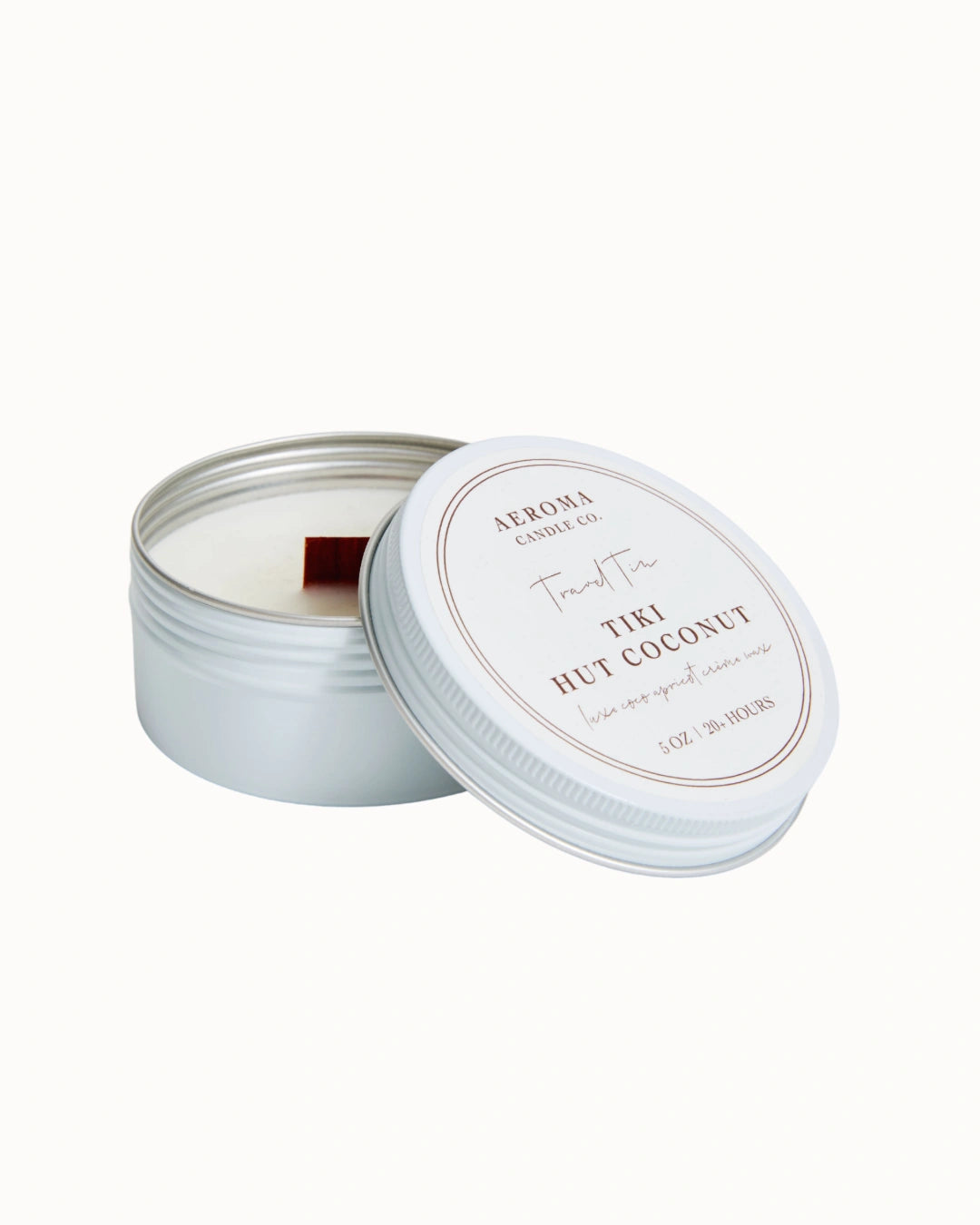 Candle in a tin with a white lid on a white background